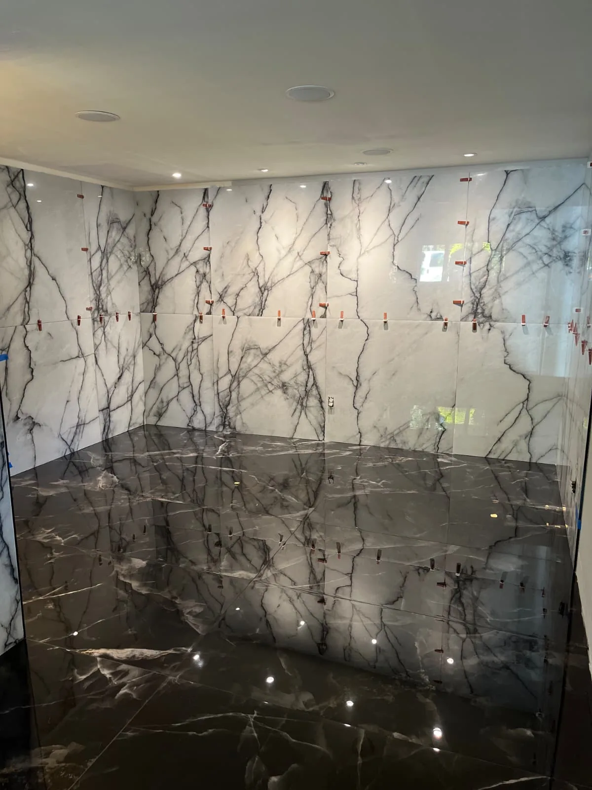 Stone-look feature wall and dark floor tile in Avon, Connecticut