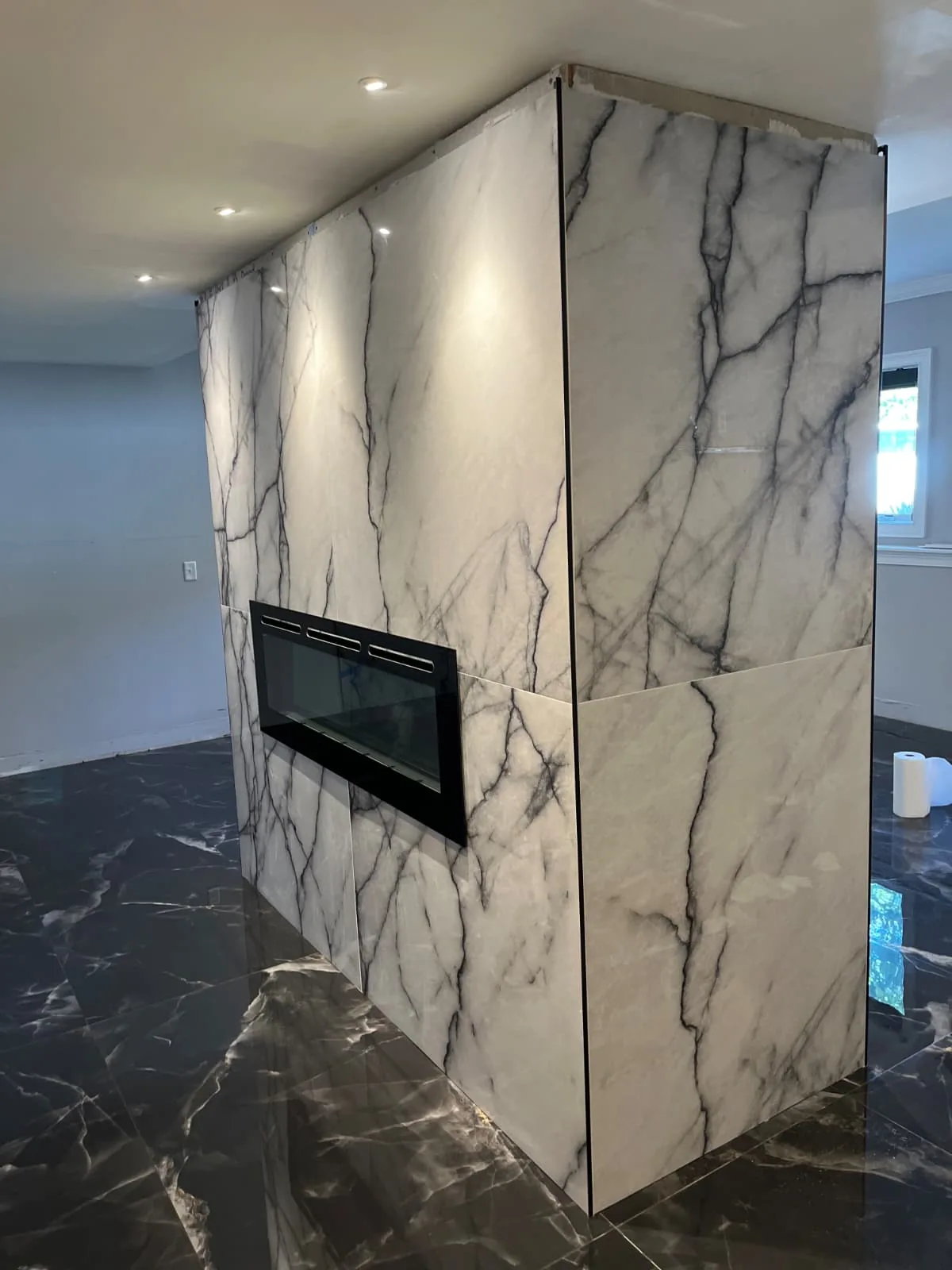 Fireplace feature wall with large stone-look panels in Avon