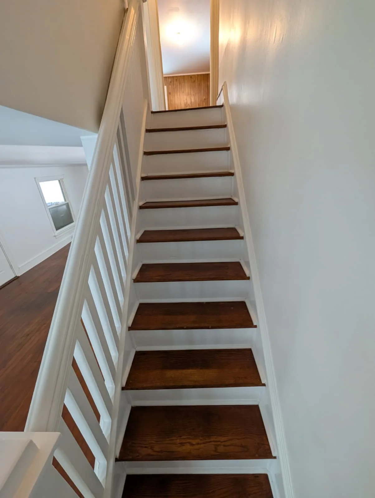 Hardwood stair flight with white railing in Glastonbury