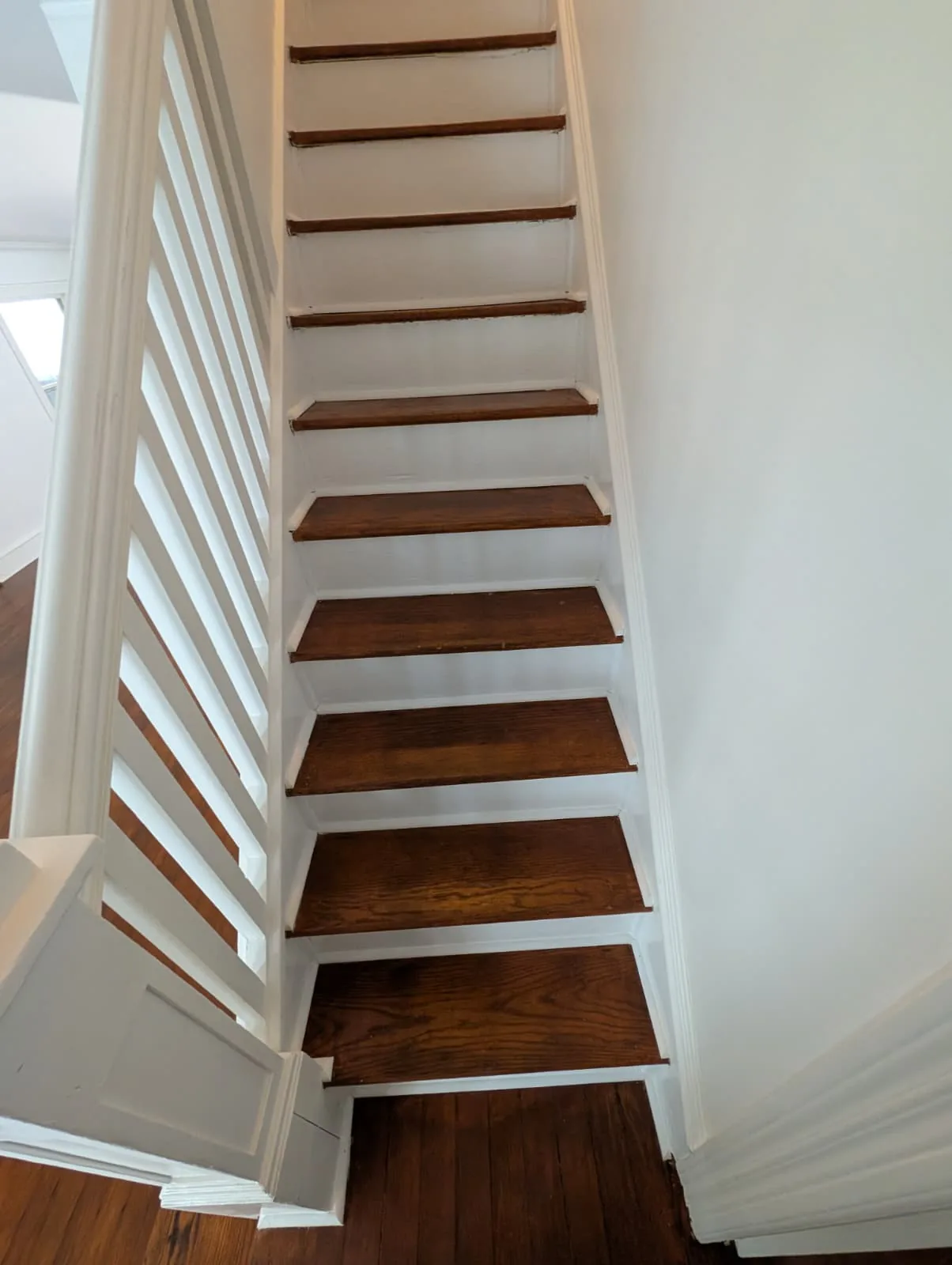 Stair treads and white balustrade in the Glastonbury home