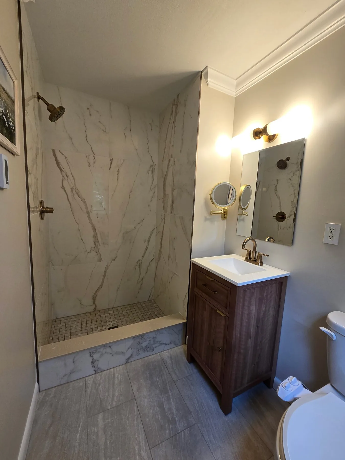Shower, vanity and tiled floor in the Unionville bathroom