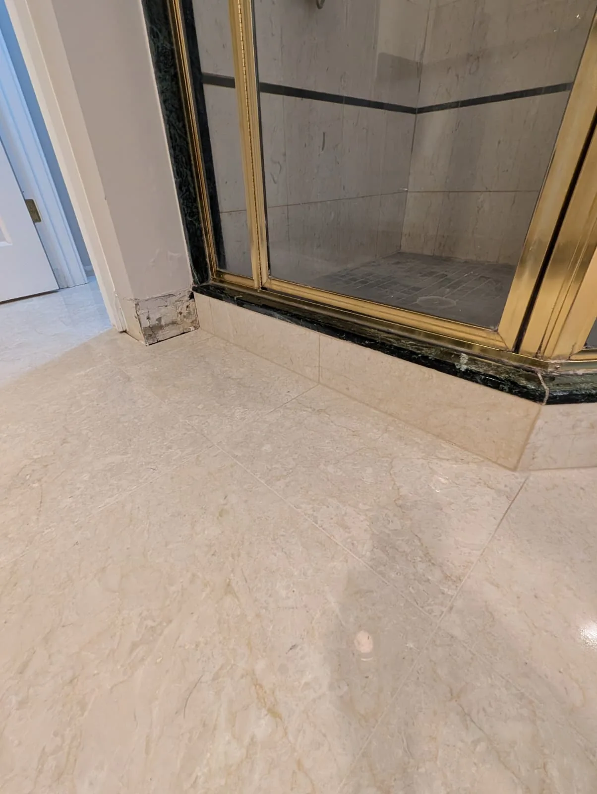 Framed glass shower and pale bathroom tile in Wethersfield, Connecticut