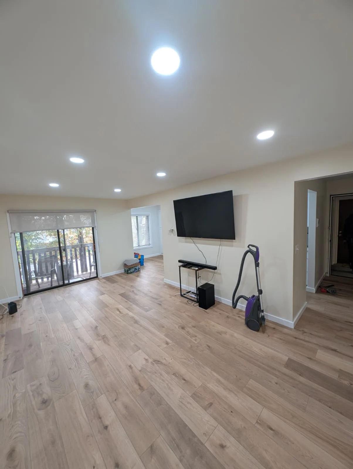 Open living room with light wood-look flooring in Newington