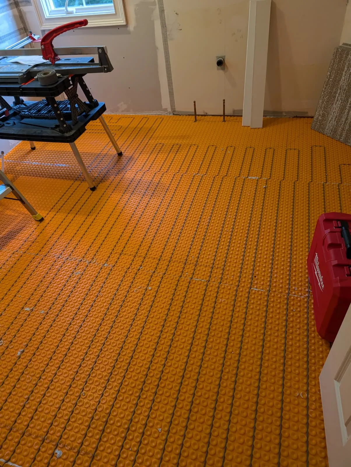 Heated floor system installed across the bathroom floor